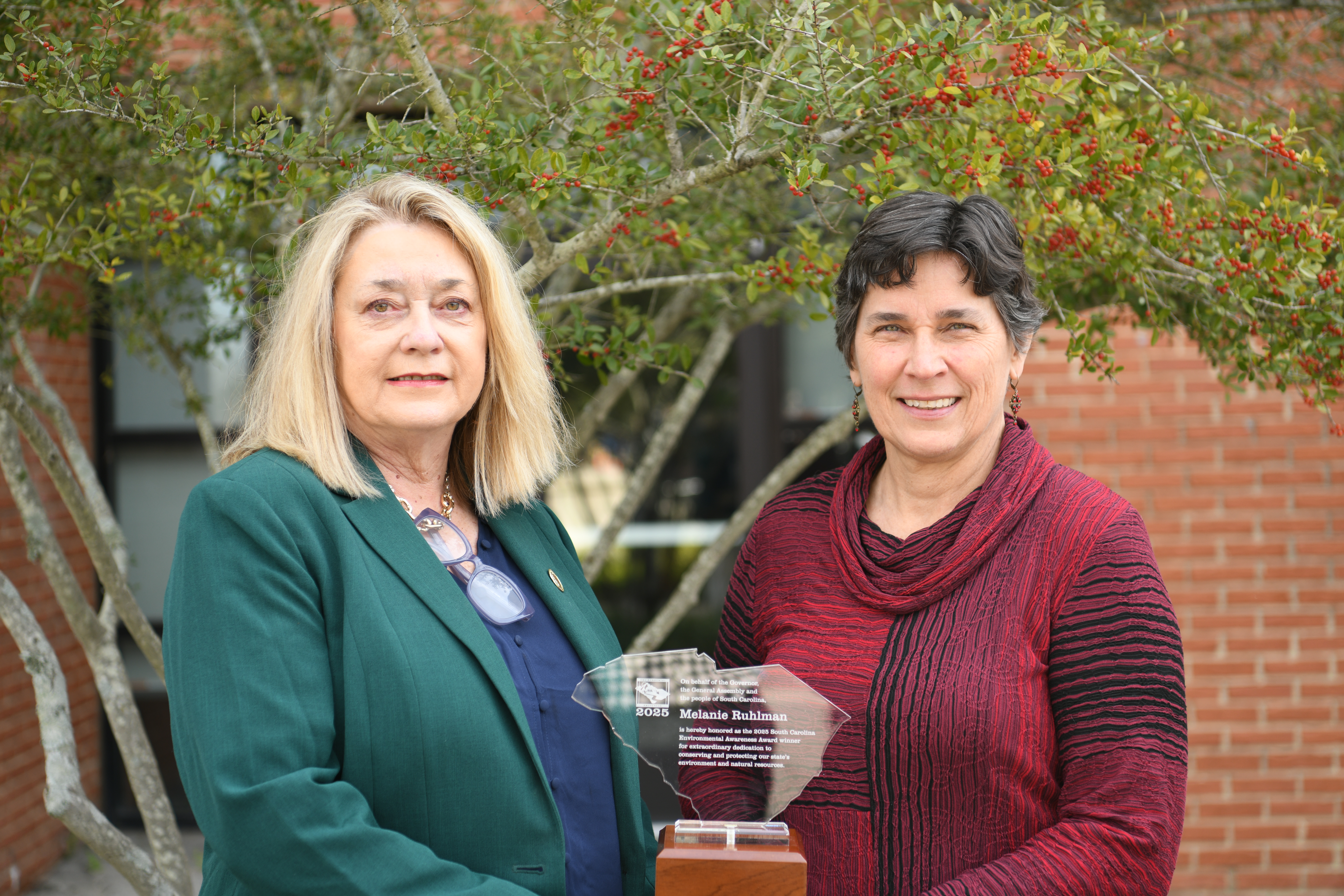Myra Reece, Director of the South Carolina Department of Environmental Services, stands with Environmental Awareness Award winner Melanie Ruhlman