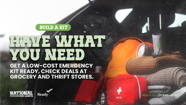 Promotional graphic for National Preparedness Month showing an emergency kit packed with items such as a first‑aid pouch, blanket, and supplies. Text reads “Build a Kit. Have What You Need. Get a low‑cost emergency kit ready. Check deals at grocery and thrift stores.” Logos for National Preparedness Month and Ready.gov appear at the bottom.