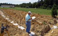 Septic tank site inspector evaluates a drainfield