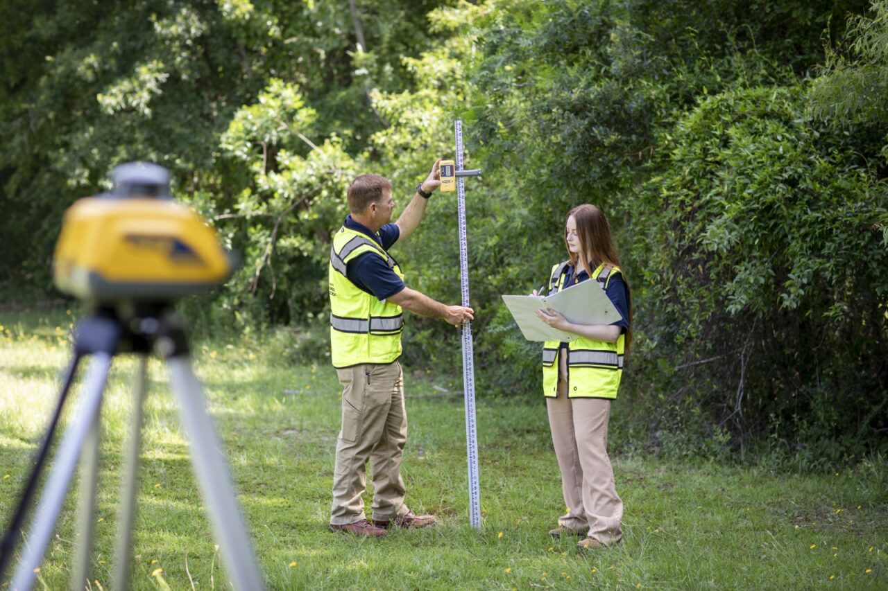 Before SCDES issues a septic tank permit, the proposed site is thoroughly assessed to make sure it can properly support a septic tank system in compliance with state environmental and public health requirements. Here, David Vaughan and Anna Lane with SCDES's Onsite Wastewater Division measure a potential septic tank site.