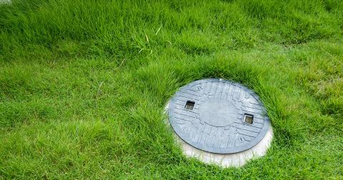 Septic tank cover on a grass lawn