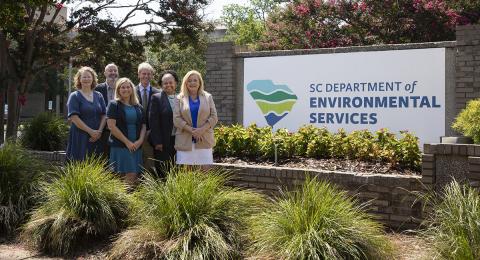 Interim Director, Myra Reece and other leadership standing in front of SCDES building sign