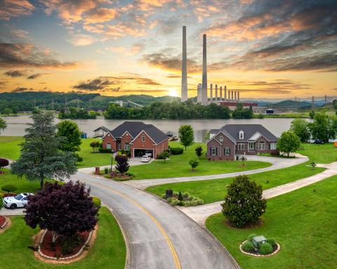 Residential district houses at coal-fired power plant producing electricity.