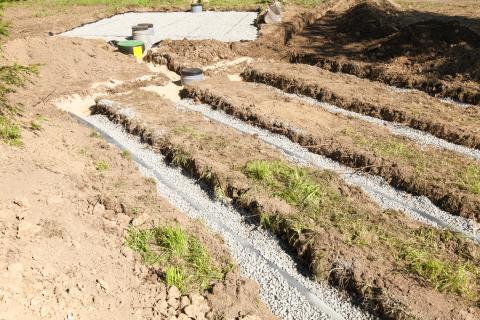 Detail of a secondary filter bed on a septic tank installation showing the position of the pipes with the primary bed behind, necessitated by clay soil and poor drainage